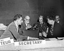 6 June 1949 Fifth session of the Human Rights Commission, United Nations, Lake Success, New York (from left to right): Mr. Charles Malik (Lebanon), Mr. René Cassin (France); and Mrs. Eleanor Roosevelt (USA), members of the Commission, discussing before a meeting on the Draft Covenant on Human Rights; Mrs. Marjorie Whiteman and Mr. James Simsarian, United States advisers, are sitting behind.